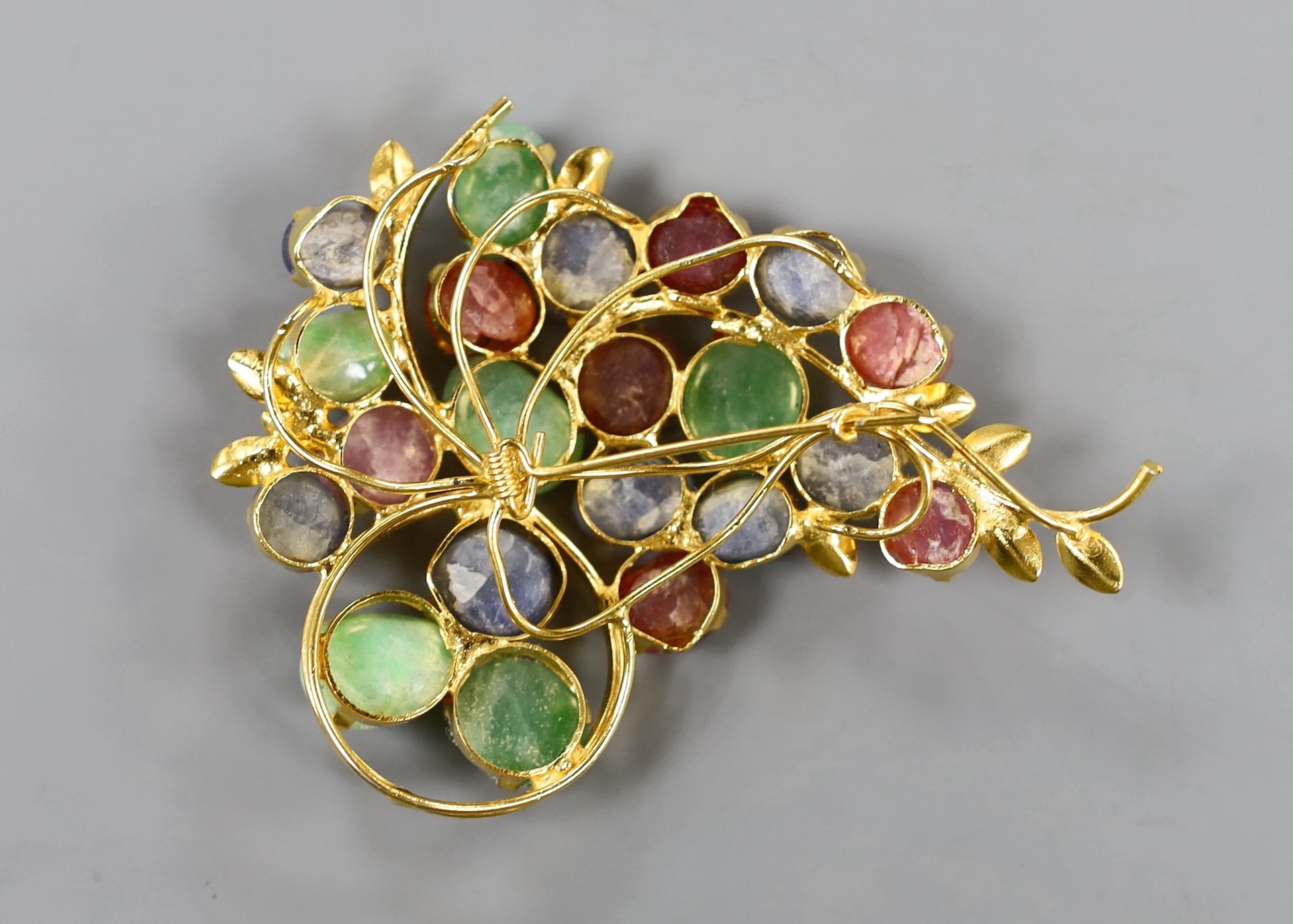 A gilt metal and multi cabochon stone set foliate spray brooch, 7cm.